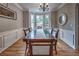 Dining area showcases a bay window, elegant chandelier, and decorative wall trim at 1325 Starboard Way, Cumming, GA 30041