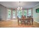 Dining room with hardwood floors, an elegant chandelier, and expansive views of the outdoors at 1325 Starboard Way, Cumming, GA 30041