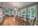 Dining room with hardwood floors, large windows, and an open view to the Gathering room at 1325 Starboard Way, Cumming, GA 30041