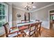 Dining area showcases a bay window, elegant chandelier, and decorative wall trim at 1325 Starboard Way, Cumming, GA 30041