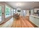 Hardwood floors in the dining area with door to the deck and adjacent to the kitchen and living spaces at 1325 Starboard Way, Cumming, GA 30041