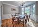 Traditional dining room featuring a bay window, chandelier, and hardwood floors at 1325 Starboard Way, Cumming, GA 30041