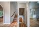 Welcoming entryway featuring wood floors, staircase with carpet, and arched doorways at 1325 Starboard Way, Cumming, GA 30041