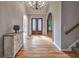 Elegant foyer boasting hardwood floors, arched doorways, and a statement chandelier at 1325 Starboard Way, Cumming, GA 30041