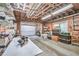 Spacious garage with fluorescent lighting, organizational shelving, and a white door at 1325 Starboard Way, Cumming, GA 30041
