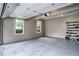 Well-lit garage with neutral paint, gray flooring, and windows offering natural light at 1325 Starboard Way, Cumming, GA 30041