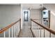 Upstairs hallway with carpet and wood and white railings at 1325 Starboard Way, Cumming, GA 30041