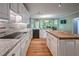 Modern kitchen with a view of the dining room and outdoor view through bay window at 1325 Starboard Way, Cumming, GA 30041