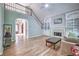 Cozy living room with a fireplace, hardwood floors, staircase to the second floor, and arched doorway at 1325 Starboard Way, Cumming, GA 30041