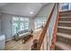 Sun-lit living room with hardwood floors, ceiling fan, and view of the deck at 1325 Starboard Way, Cumming, GA 30041
