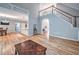 Open-concept living area with hardwood floors, high ceilings, and staircase to the second floor at 1325 Starboard Way, Cumming, GA 30041