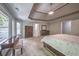 Bright main bedroom features neutral walls, tray ceiling, furniture, and lots of natural light at 1325 Starboard Way, Cumming, GA 30041