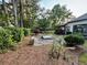 Beautiful backyard with a brick patio, manicured landscaping, and mature trees at 2610 Stokesley Way, Snellville, GA 30078