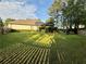 Well-manicured backyard with a large lawn and mature trees at 2610 Stokesley Way, Snellville, GA 30078