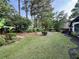 Expansive backyard featuring well-maintained lawn, lush landscaping, and mature trees at 2610 Stokesley Way, Snellville, GA 30078