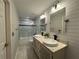 Well-lit bathroom featuring dual sinks, modern mirrors, and updated fixtures at 2610 Stokesley Way, Snellville, GA 30078