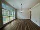 Dining room with hardwood floors, large windows, and elegant lighting fixture at 2610 Stokesley Way, Snellville, GA 30078