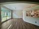 Dining room featuring hardwood floors, large windows, and a stylish chandelier at 2610 Stokesley Way, Snellville, GA 30078