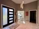 Elegant foyer featuring marble floors, stylish lighting, and an inviting view into the home office at 2610 Stokesley Way, Snellville, GA 30078