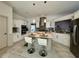 Bright kitchen featuring stainless steel appliances, sleek cabinetry, tile floors, and island seating at 2610 Stokesley Way, Snellville, GA 30078