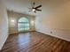 Bright living room with hardwood floors, large arched window, and recessed lighting at 2610 Stokesley Way, Snellville, GA 30078