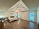 Spacious main bedroom with hardwood floors, tray ceilings, large windows, and neutral decor at 2610 Stokesley Way, Snellville, GA 30078