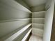 Walk-in pantry with white shelving and plenty of storage space at 2610 Stokesley Way, Snellville, GA 30078