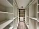 Expansive walk-in closet with custom shelving and ample storage space at 2610 Stokesley Way, Snellville, GA 30078