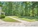 Expansive backyard of this home with mature trees and a partial view of the playset at 4840 Chapel Hill Rd, Douglasville, GA 30135