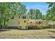 Expansive backyard view of the two-story home, including a wooden deck, and a lush green lawn at 4840 Chapel Hill Rd, Douglasville, GA 30135