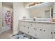 Bright bathroom featuring a double vanity with white cabinets and a bathtub at 4840 Chapel Hill Rd, Douglasville, GA 30135