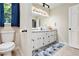Bright bathroom features a double vanity with white cabinets and neutral tile flooring at 4840 Chapel Hill Rd, Douglasville, GA 30135