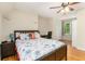 Bedroom featuring wood flooring, a ceiling fan, and a comfortable bed at 4840 Chapel Hill Rd, Douglasville, GA 30135