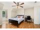 Bedroom featuring wood flooring, a ceiling fan, and a comfortable bed at 4840 Chapel Hill Rd, Douglasville, GA 30135
