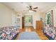 Bright bedroom with hardwood floors, ceiling fan, natural light, and closet space at 4840 Chapel Hill Rd, Douglasville, GA 30135