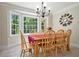 Inviting dining room featuring a large window, chandelier, and wooden table with chairs at 4840 Chapel Hill Rd, Douglasville, GA 30135