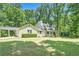 Charming home with well-manicured lawn, inviting front porch, and playset in a beautiful, wooded setting at 4840 Chapel Hill Rd, Douglasville, GA 30135