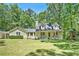 Charming home with well-manicured lawn, inviting front porch, and playset in a beautiful, wooded setting at 4840 Chapel Hill Rd, Douglasville, GA 30135