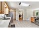 Well-lit kitchen featuring tile floors, stainless steel appliances, and wood cabinets at 4840 Chapel Hill Rd, Douglasville, GA 30135