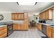 Open kitchen design with wood cabinets, stainless appliances, and adjacent breakfast nook at 4840 Chapel Hill Rd, Douglasville, GA 30135