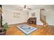 Light-filled living room featuring hardwood floors, staircase, piano, and a decorative rug at 4840 Chapel Hill Rd, Douglasville, GA 30135