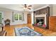 Cozy living room featuring hardwood floors, a fireplace, and lots of natural light at 4840 Chapel Hill Rd, Douglasville, GA 30135