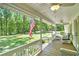 Inviting front porch with outdoor seating area and ceiling fans to sit back and relax at 4840 Chapel Hill Rd, Douglasville, GA 30135