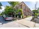 Multi-story brick exterior featuring mature trees and landscaping around the property, with on-street parking available at 733 Frederica Ne St # 17, Atlanta, GA 30306
