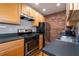 Modern kitchen features stainless steel appliances, and exposed brick accent wall at 733 Frederica Ne St # 17, Atlanta, GA 30306