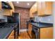 Efficient kitchen featuring stainless appliances, black countertops, and in-unit laundry at 733 Frederica Ne St # 17, Atlanta, GA 30306