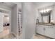 Neutral bathroom with a granite countertop and vanity with white shaker cabinets at 771 Phil Haven Ln, Kennesaw, GA 30152