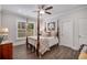 Bedroom suite showcasing a four-poster bed, neutral walls, and wood flooring at 771 Phil Haven Ln, Kennesaw, GA 30152