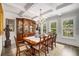 Elegant dining room with hardwood floors, crystal chandelier, and custom china cabinet at 771 Phil Haven Ln, Kennesaw, GA 30152