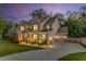 Elegant two-story home with a spacious driveway and well-lit exterior, creating an inviting atmosphere at 771 Phil Haven Ln, Kennesaw, GA 30152